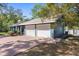 Spacious two-car garage with brick driveway offers ample parking and convenient access to the home at 1267 Meredith Dr, Spring Hill, FL 34608