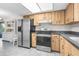 A spacious kitchen features stainless steel appliances and wooden cabinets at 1267 Meredith Dr, Spring Hill, FL 34608