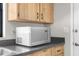 The kitchen features a microwave and black countertops at 1267 Meredith Dr, Spring Hill, FL 34608