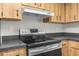 The kitchen showcases a stainless steel oven and ample wood cabinetry at 1267 Meredith Dr, Spring Hill, FL 34608