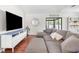 Cozy living room featuring a plush sectional sofa, a TV, and a view to the backyard at 1267 Meredith Dr, Spring Hill, FL 34608