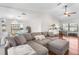 Open-concept living space with hardwood floors, comfortable seating and lots of natural light at 1267 Meredith Dr, Spring Hill, FL 34608