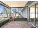 View of the outdoor, screened-in patio with red brick floor at 1267 Meredith Dr, Spring Hill, FL 34608