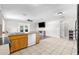 Open-concept kitchen featuring stone countertops, stainless appliances, wood floors and lots of natural light at 1283 Coble Rd, Spring Hill, FL 34608