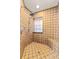 A fully tiled shower stall featuring tile flooring, a built-in seat, and a shower head with controls at 1353 Spring Lake Hwy, Brooksville, FL 34602