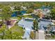 An aerial view of a quiet neighborhood with a lake and enclosed pool, with lots of trees at 15911 Crying Wind Dr, Tampa, FL 33624