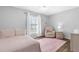 Bedroom with hardwood floors, neutral color scheme, and a large window with natural light at 15911 Crying Wind Dr, Tampa, FL 33624