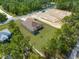 Beautiful aerial view of home with a large manicured lawn and a construction site nearby at 16043 Penn State Rd, Weeki Wachee, FL 34614