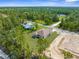 Aerial view of the home on a large wooded lot, backing onto a tree lined street at 16043 Penn State Rd, Weeki Wachee, FL 34614