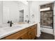 Bathroom featuring a marble countertop, modern fixtures, and a shower with glass doors offering an inviting space at 16043 Penn State Rd, Weeki Wachee, FL 34614