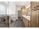 A bright bathroom showcases dual vanities, wood cabinets and a glass shower at 16043 Penn State Rd, Weeki Wachee, FL 34614