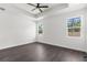This large bedroom features an elegant tray ceiling, ceiling fan and two windows letting in natural light and exterior views at 16043 Penn State Rd, Weeki Wachee, FL 34614