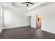 Spacious bedroom featuring dark wood floors, a ceiling fan, and an ensuite bathroom for added convenience at 16043 Penn State Rd, Weeki Wachee, FL 34614