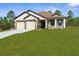 Charming home with a well-manicured lawn, two-car garage, and stone-accented facade at 16043 Penn State Rd, Weeki Wachee, FL 34614