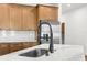 Close-up of a kitchen island with a modern faucet, stainless steel appliances, and subway tile backsplash at 16043 Penn State Rd, Weeki Wachee, FL 34614