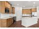 Stylish kitchen with wood cabinets, sleek appliances, an island, and a white subway tile backsplash at 16043 Penn State Rd, Weeki Wachee, FL 34614