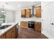Well-lit kitchen showcases wood cabinets, stainless steel appliances, and an open design for easy living and entertaining at 16043 Penn State Rd, Weeki Wachee, FL 34614