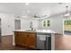 Kitchen island showcasing granite countertops, stainless steel dishwasher, and overhead lighting offering space to cook at 16043 Penn State Rd, Weeki Wachee, FL 34614