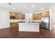 Well-equipped kitchen with stainless appliances, subway tile, expansive island and wood look flooring at 16043 Penn State Rd, Weeki Wachee, FL 34614