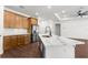 Bright kitchen with stainless steel appliances, wooden cabinets, and a marble top island for food preparation and storage at 16043 Penn State Rd, Weeki Wachee, FL 34614