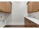 Clean laundry room with ample cabinets, counter space, and stylish finishes for added convenience at 16043 Penn State Rd, Weeki Wachee, FL 34614