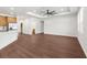 Bright, open-concept living space with wood-look floors, tray ceiling, and an open view to the kitchen at 16043 Penn State Rd, Weeki Wachee, FL 34614