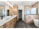 Spacious bathroom with double vanity, marble countertops, frameless shower, and freestanding tub at 16043 Penn State Rd, Weeki Wachee, FL 34614