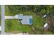 Overhead aerial view of property showcasing the home, pool, extensive greenery, and outbuildings at 16386 Heron Hills Dr, Spring Hill, FL 34610