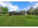 Lush backyard featuring a screened in pool and plenty of space to roam at 16386 Heron Hills Dr, Spring Hill, FL 34610