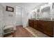 Bathroom featuring double sinks, granite countertops, and spacious design for convenient and stylish living at 16386 Heron Hills Dr, Spring Hill, FL 34610
