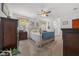 Cozy bedroom with neutral carpet, ceiling fan, and natural light creating a relaxing and inviting atmosphere at 16386 Heron Hills Dr, Spring Hill, FL 34610