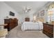 Spacious carpeted bedroom with ceiling fan, white trim, and ample natural light at 16386 Heron Hills Dr, Spring Hill, FL 34610