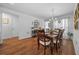 Dining room with chandelier, wood floors, and natural light from large windows at 16386 Heron Hills Dr, Spring Hill, FL 34610