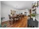 Spacious dining area flows into kitchen, featuring hardwood floors, elegant chandelier, and ample room for entertaining at 16386 Heron Hills Dr, Spring Hill, FL 34610