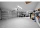 Expansive three-car garage featuring a durable epoxy floor and extensive storage solutions at 16386 Heron Hills Dr, Spring Hill, FL 34610