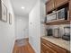 Hallway features granite counter space with microwave and small appliance storage at 16386 Heron Hills Dr, Spring Hill, FL 34610