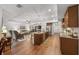 Open-concept kitchen and living area with granite island, stainless appliances, and stylish furnishings at 16386 Heron Hills Dr, Spring Hill, FL 34610