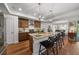Open kitchen showcasing a large island with seating, granite counters, and modern stainless appliances at 16386 Heron Hills Dr, Spring Hill, FL 34610
