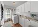 Efficient laundry room with modern washer and dryer, ample storage, and functional design for easy chore management at 16386 Heron Hills Dr, Spring Hill, FL 34610
