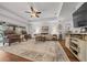 Spacious living room with cozy seating, a ceiling fan, and a view of the outdoors at 16386 Heron Hills Dr, Spring Hill, FL 34610