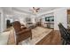 Cozy living room featuring comfortable furnishings, hardwood floors, and ample natural light at 16386 Heron Hills Dr, Spring Hill, FL 34610