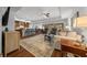 Open-concept living room with a breakfast bar, hardwood floors, and neutral tones at 16386 Heron Hills Dr, Spring Hill, FL 34610