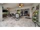 Inviting covered patio area with ceiling fans, outdoor dining and seating, perfect for relaxing and entertaining at 16386 Heron Hills Dr, Spring Hill, FL 34610