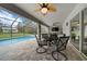 Screened patio with swimming pool, ceiling fans, outdoor dining, and seating, offering a relaxing outdoor space at 16386 Heron Hills Dr, Spring Hill, FL 34610