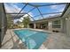 Inviting screened pool with paved patio and comfortable lounge chairs for poolside enjoyment at 16386 Heron Hills Dr, Spring Hill, FL 34610