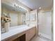 Bright bathroom boasts a large mirror, ample countertop space, and a glass-enclosed shower at 18045 Tarrington Pl, Hudson, FL 34667