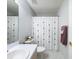 Bright bathroom featuring a neutral color scheme, single sink vanity, and a shower with a decorative curtain at 18045 Tarrington Pl, Hudson, FL 34667