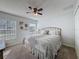 Comfortable bedroom featuring a queen-size bed, ceiling fan, and bright natural light at 18045 Tarrington Pl, Hudson, FL 34667