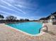 Large community pool with brick surround and ample lounge seating for residents at 18045 Tarrington Pl, Hudson, FL 34667