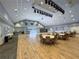 Spacious community room with hardwood flooring, round tables, and ample lighting for gatherings at 18045 Tarrington Pl, Hudson, FL 34667